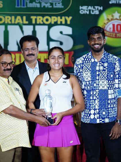 A duplicate image capturing the proud moment of our player receiving her singles trophy at the AITA Women's Open.