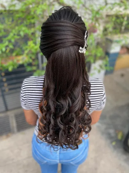 An advanced ponytail with curls, perfect for a Christian bridal look or a modern reception. The top section features intricate texturing and weaving for a high-fashion feel.