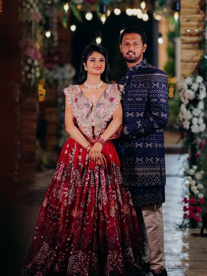 A beautiful portrait of the couple. The bride's red lehenga and the groom's blue sherwani create a stunning color combination.