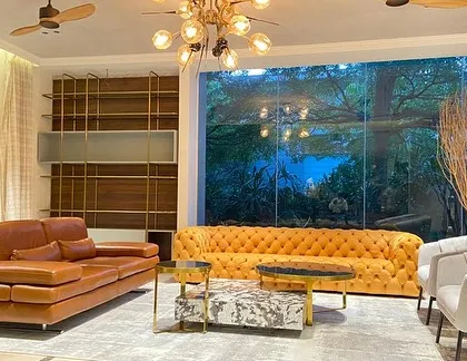 Another angle of the stunning living room, showing our tan leather sofa and a unique coffee table set made of granite and marble.