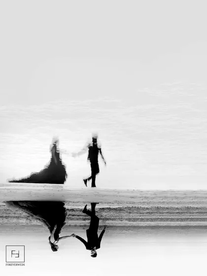 An artistic, abstract vision of love. This black and white reflection shot of Ishu and Arihant is a piece of fine art. It transforms a simple walk on the beach into a surreal and beautiful composition.