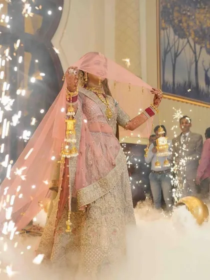 Another shot of this bride's grand entry. She looks like she's floating through the smoke and sparklers.