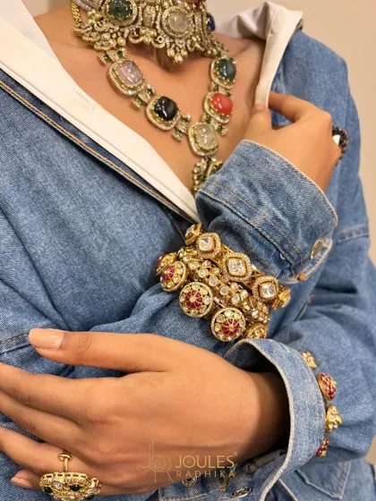A complete layered look, featuring a Navratan choker and long necklace, paired with stacked kundan kadas worn over a denim jacket for a bold fusion statement.
