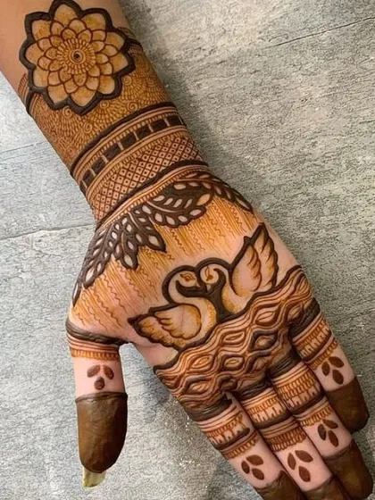A graceful design for the back of the hand, featuring a pair of swans symbolizing love and partnership, perfect for an anniversary or engagement.
