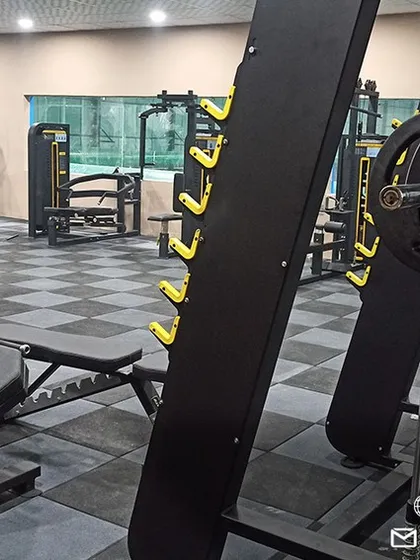 A closer look at our heavy-duty strength training equipment, including a squat rack and leg press, essential for building explosive power for the court.