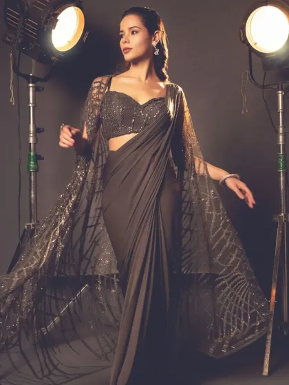 The cape saree is a modern classic, and this piece in a sophisticated grey is one of my favorites. The flowing cape adds a touch of drama and grace, creating a powerful yet elegant silhouette.