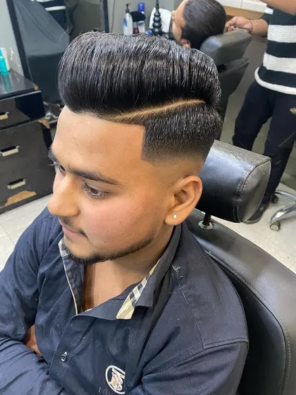 A perfect high-volume pompadour isn't just about height, it's about the flawless blend. Here, I executed a clean skin fade that transitions smoothly into a full, styled top.