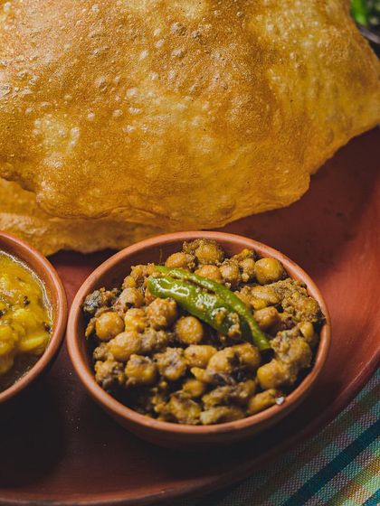 A close-up of our weekend Poori Platter. The combination of hot, fluffy pooris with spicy chole and tangy aloo sabzi is simply unbeatable.