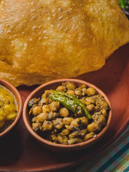 A close-up of our weekend Poori Platter. The combination of hot, fluffy pooris with spicy chole and tangy aloo sabzi is simply unbeatable.