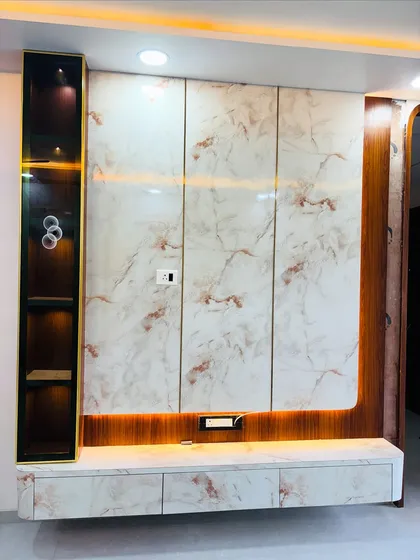 This angle shows the glossy finish of the laminates and the clean lines of the TV unit design. The rounded corner on the console is a soft, modern touch.