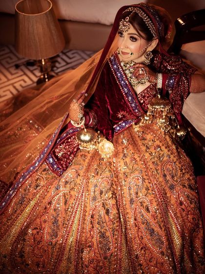 A full-length shot of the bride, showcasing the grandeur of her lehenga and kaleeras.