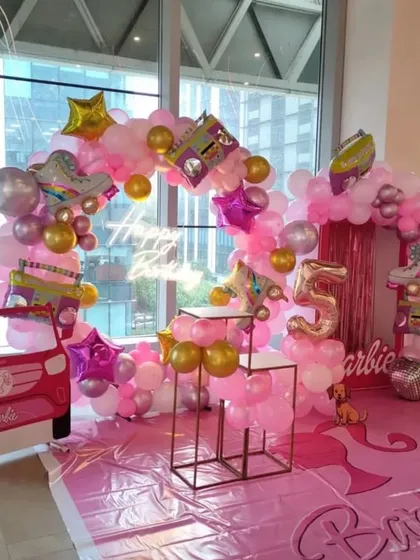 We went all out for this 5th birthday with a retro Barbie theme. The decor features a large pink balloon arch accented with roller skate and boombox foil balloons, plus a kid-sized Barbie car cutout for the ultimate play and photo prop.