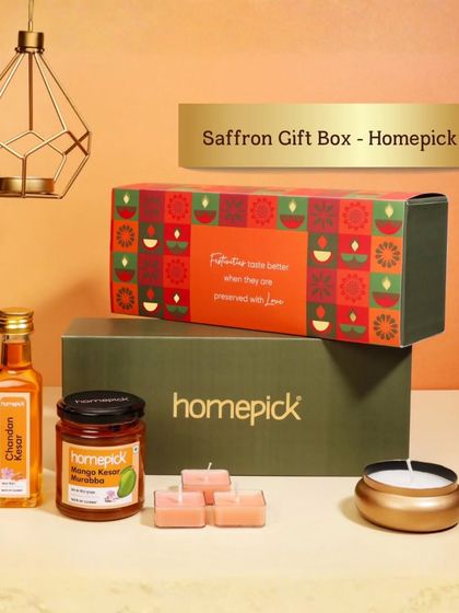 This Saffron Gift Box makes for a luxurious and traditional wedding gift. It includes saffron-infused syrup, mango kernel pickle, and scented candles for a touch of festive elegance.