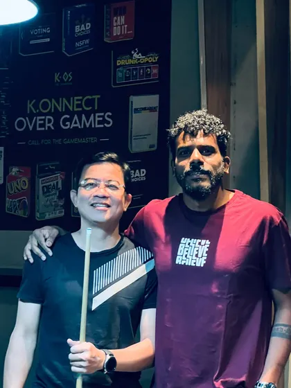 Friday nights are for connecting over games. Here are two regulars enjoying a game of pool, soaking in the lively atmosphere of a packed house.