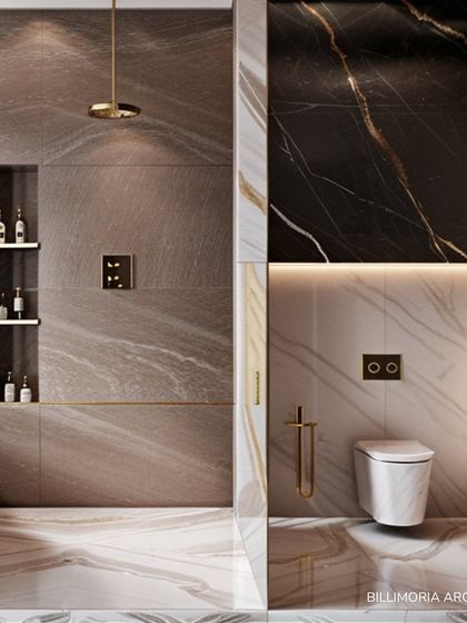 We used three distinct marble patterns in this bathroom to create a visually rich and luxurious space. The design includes a walk-in shower with a gold rain showerhead and a built-in niche for toiletries, combining beauty with practicality.