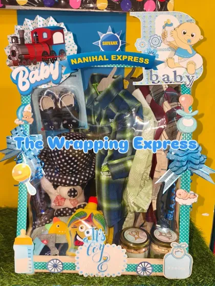 A 'Nanihal Express' themed hamper for a baby boy named Shivank, filled with clothes and accessories.