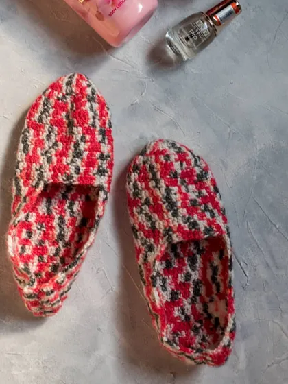 A top-down view of our handmade loafer-style socks. They are made with soft, warm yarn to keep your feet comfortable on cold floors.