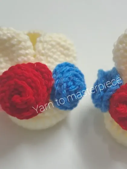 A close-up of the bunny booties, showing the detail of the multi-colored roses and the cute bunny ear shape.