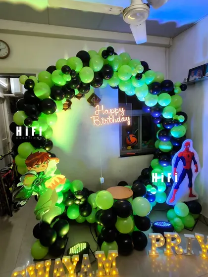 Your child's favorite heroes can make an appearance at their party. This action-packed birthday setup combines the worlds of Ben 10 and Spiderman with a custom balloon arch, character cutouts, and marquee letters, all designed to fit perfectly in a home setting.