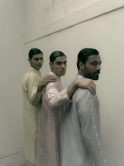 A moody, atmospheric shot for Sanchit Sharma. The models are arranged in a line, creating a strong visual rhythm, while the desaturated tones add a timeless quality.