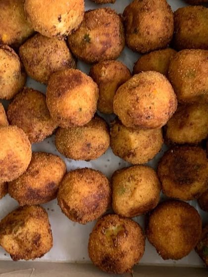 A box full of my popular Corn & Cheese Balls, fried to golden perfection.