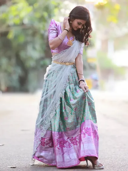 A full-length shot that captures a moment of movement, with the model looking down at her skirt. This adds a dynamic and candid feel.