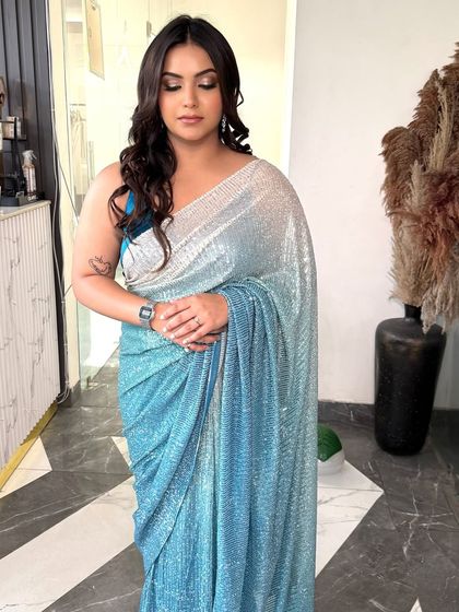 The full look, showing how the cool-toned makeup complements her sequined saree. This is a perfect example of a glamorous and modern party style.