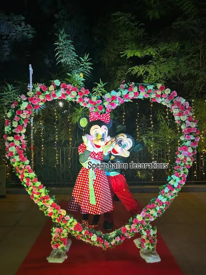 A picture-perfect moment with Mickey and Minnie Mouse inside a custom floral heart arch. I can help arrange these special photo opportunities to capture beautiful memories from your celebration or event.