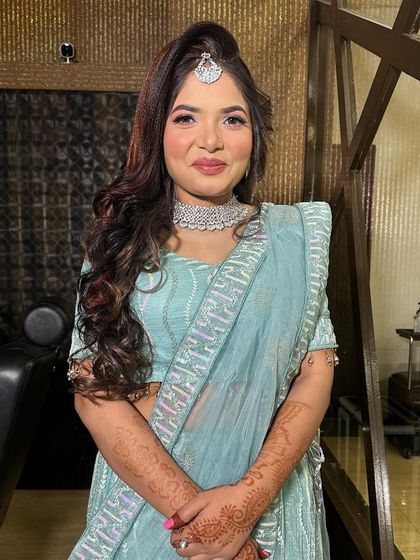 She’s all smiles and ready for her engagement. The high ponytail and bright eye makeup create a youthful and modern bridal look.