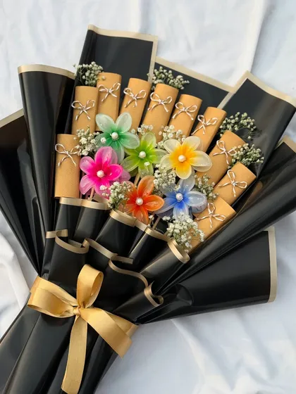 A trendy and useful gift for your girlfriends or as a bachelorette favor. This unique bouquet is made of colorful flower-shaped hair clips, combining aesthetics with utility.