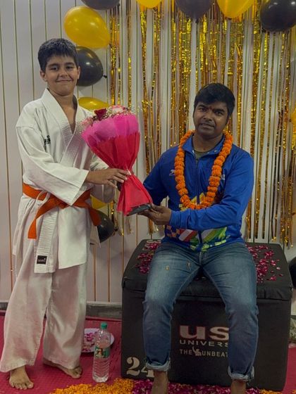 Another young orange belt student participating in our Teacher's Day celebration, part of our academy's family culture.