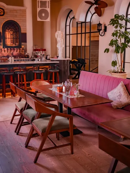 A cozy nook by the bar, where velvet seating and warm wood floors invite you to settle in for the evening. It’s a perfect spot to enjoy a drink and watch the stories of the night unfold.