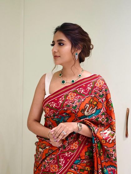 The client looking stunning at her jewelry store opening. The simple, elegant bun allows her beautiful saree and jewelry to take center stage.