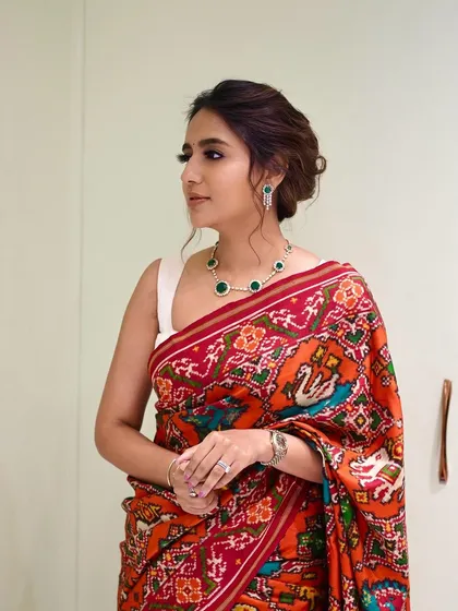 The client looking stunning at her jewelry store opening. The simple, elegant bun allows her beautiful saree and jewelry to take center stage.