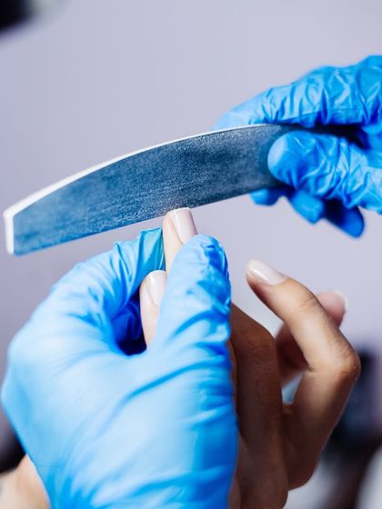 The foundation of a perfect manicure. Our technician carefully files the nail to create a smooth and uniform shape, ensuring a flawless result.