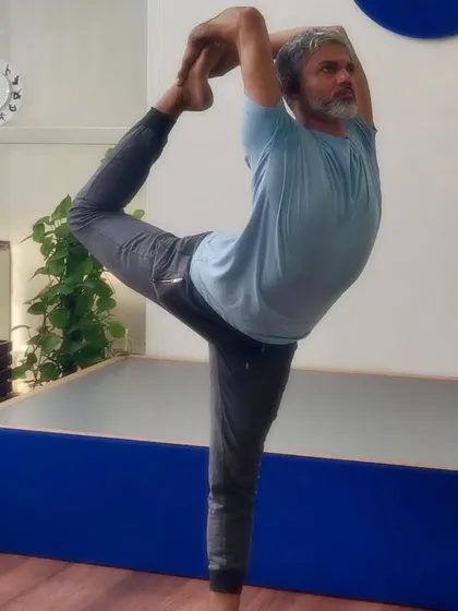My background as a dancer deeply influences my practice. Here in Natarajasana, or Lord of the Dance Pose, I find a connection between rhythmic movement and steady balance. This asana builds focus, opens the shoulders, and strengthens the legs.