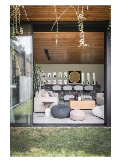 The lounge opens directly onto the lawn, blurring the lines between indoor and outdoor living.