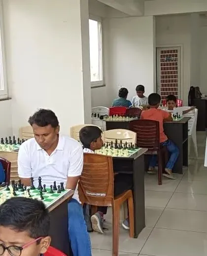 A wide shot of our tournament hall, filled with students of various ages, each focused on their own strategic battle.