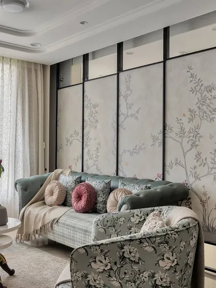 This space demonstrates how to blend different styles seamlessly. The classic silhouette of the chesterfield sofa is updated with floral upholstery, creating a beautiful tension between traditional and contemporary design.