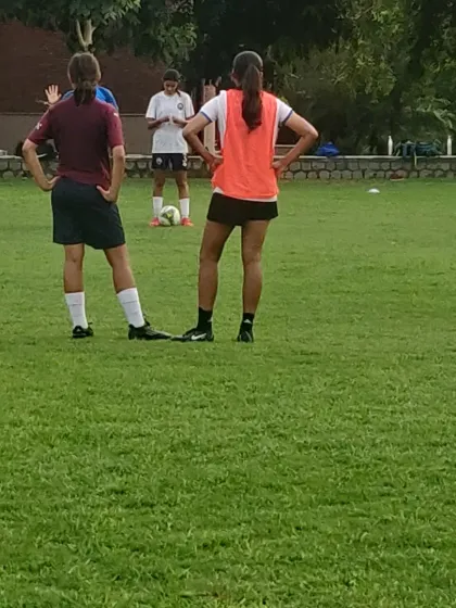 Players in our girls' program listen to instructions before a drill. Team talks and strategy are a key part of every session.