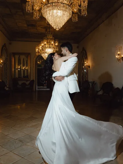 A fairytale first dance under magnificent crystal chandeliers. My goal is to frame these iconic reception moments with a sense of drama and timeless romance, creating a memory that feels magical.