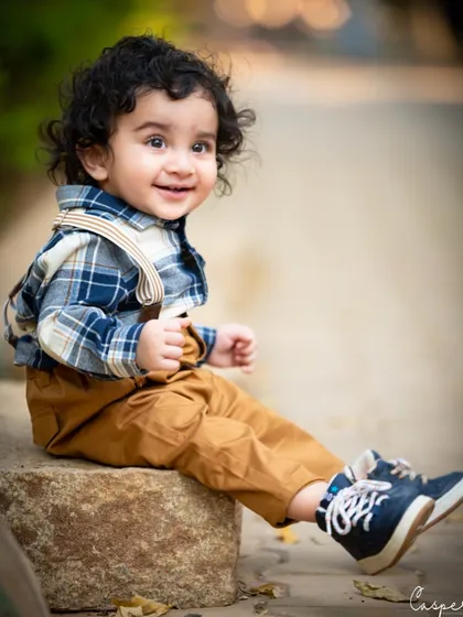 A bright, happy smile from this dapper little man. The soft, blurred background keeps all the focus on his joyful expression.