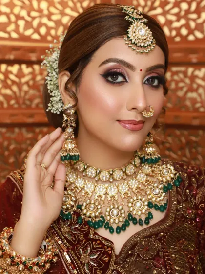 A classic bridal portrait with a focus on the kundan jewelry. The makeup is kept elegant and defined to complement the heavy accessories.