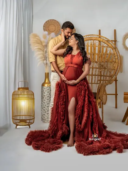 An intimate pose that captures the love and connection between the expecting couple in our boho-chic studio.