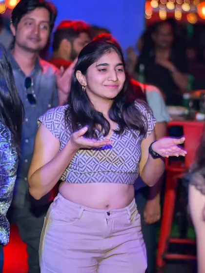 The crowd isn't just watching, they are part of the performance. Here's a guest dancing along while her friends are up on stage.