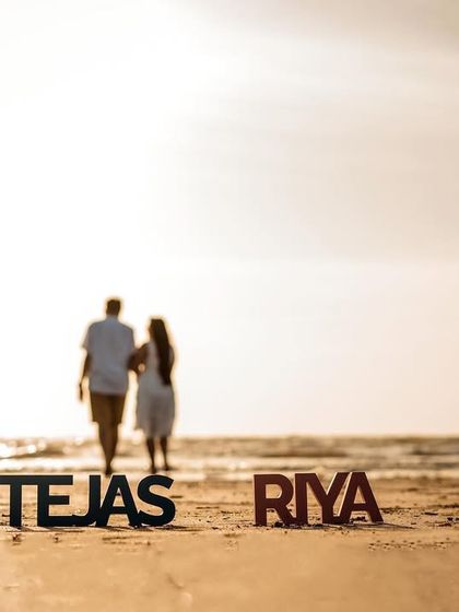 A creative shot using personalized name props, with the couple walking away into the sunset, symbolizing the start of their new journey.