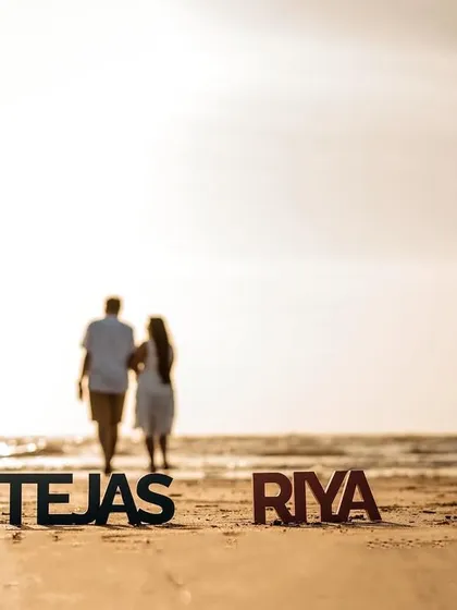 A creative shot using personalized name props, with the couple walking away into the sunset, symbolizing the start of their new journey.