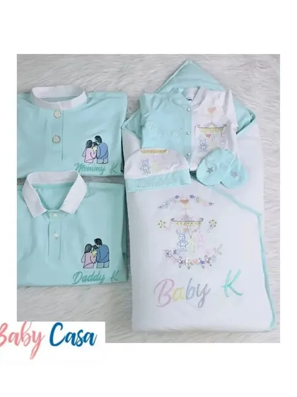 A complete family twinning set. This combo includes a personalized baby wrap and romper, along with matching "Mommy K" and "Daddy K" shirts, all in a lovely mint green.