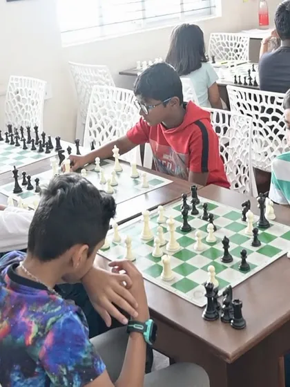 Students of various ages deeply engaged in their matches. This image captures the typical atmosphere of our group classes, fostering both competition and camaraderie.