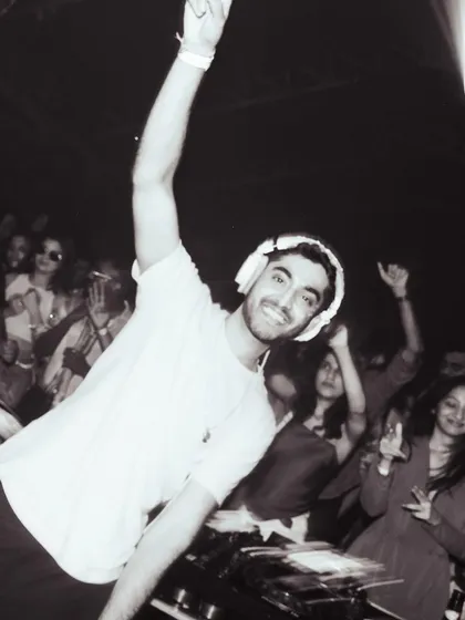 A black and white shot of me connecting with the crowd during a set. A smile and a hand in the air, it’s all about sharing the good vibes.